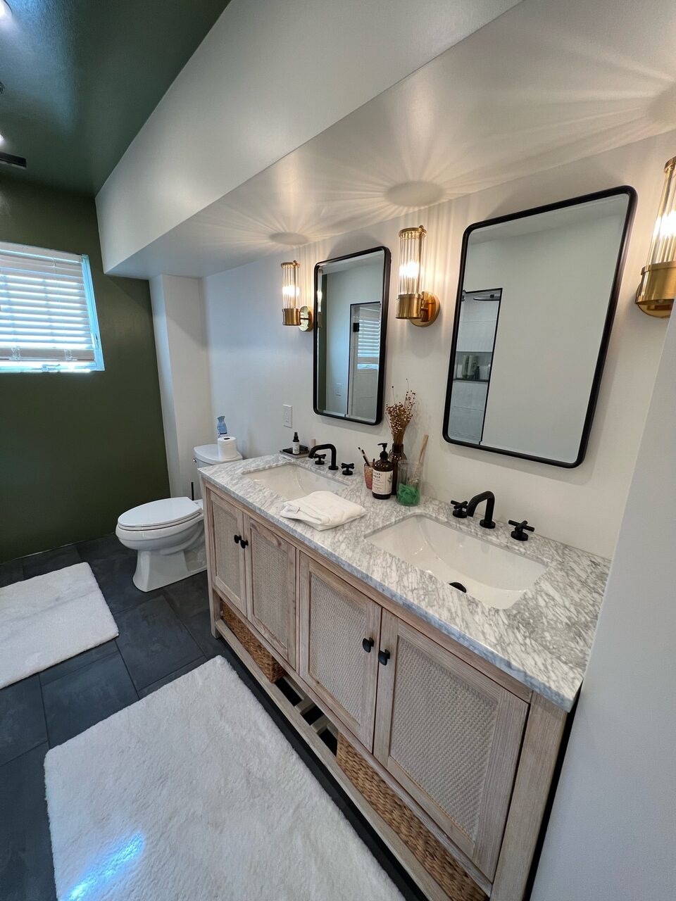 Double vanity with green feature wall
